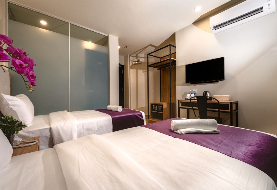 Twin-bed guest room — BIG M Hotel