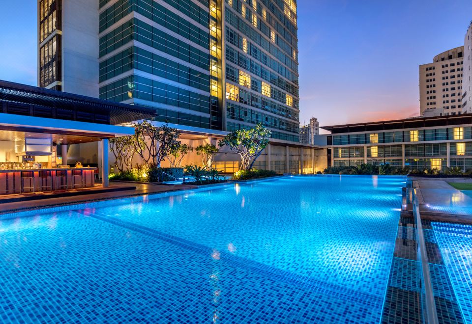 Outdoor pool at dusk — Pullman Bangkok King Power