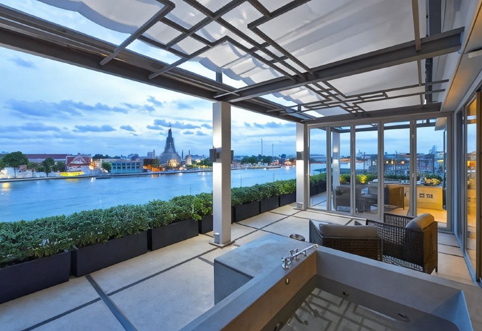 River-facing terrace seating — Riva Arun Bangkok